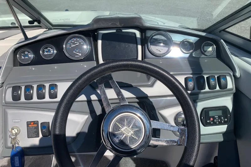 Slide: The Image of Dashboard of a 2015 Bryant Calandra boat with steering wheel and gauges. - 10