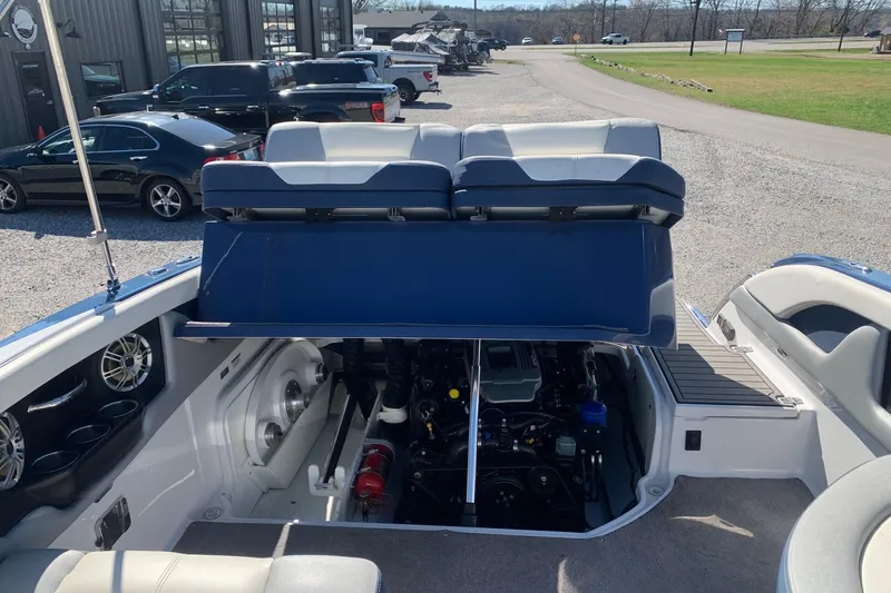 Slide: The Image of 2015 Bryant Calandra boat with open engine compartment, showcasing interior and seating. - 11