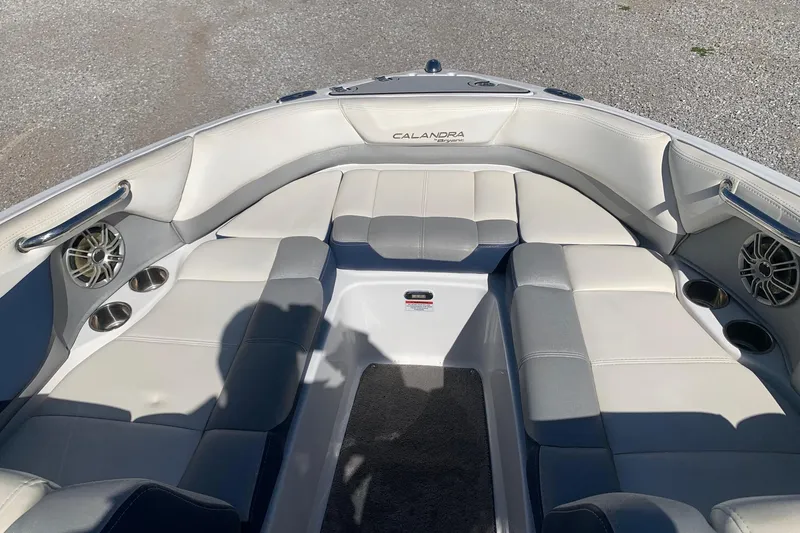 Slide: The Image of 2015 Bryant Calandra boat interior with white seating and built-in speakers. - 13