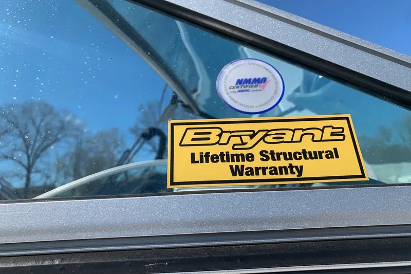 Slide: The Image of Sticker on Bryant Calandra 2015 boat window, showing lifetime structural warranty and NMMA certification. - 19