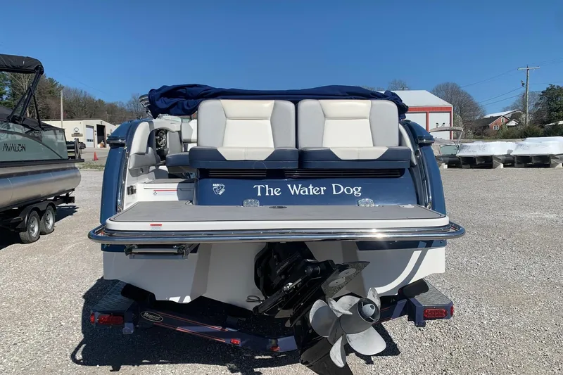 Slide: The Image of 2015 Bryant Calandra boat named "The Water Dog" parked on gravel lot. - 2
