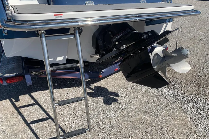 Slide: The Image of 2015 Bryant Calandra boat with ladder and MerCruiser propeller on gravel surface. - 20