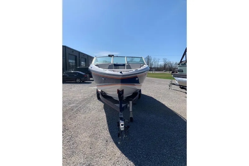 Slide: The Image of 2015 Bryant Calandra boat on trailer in outdoor setting under clear blue sky. - 4
