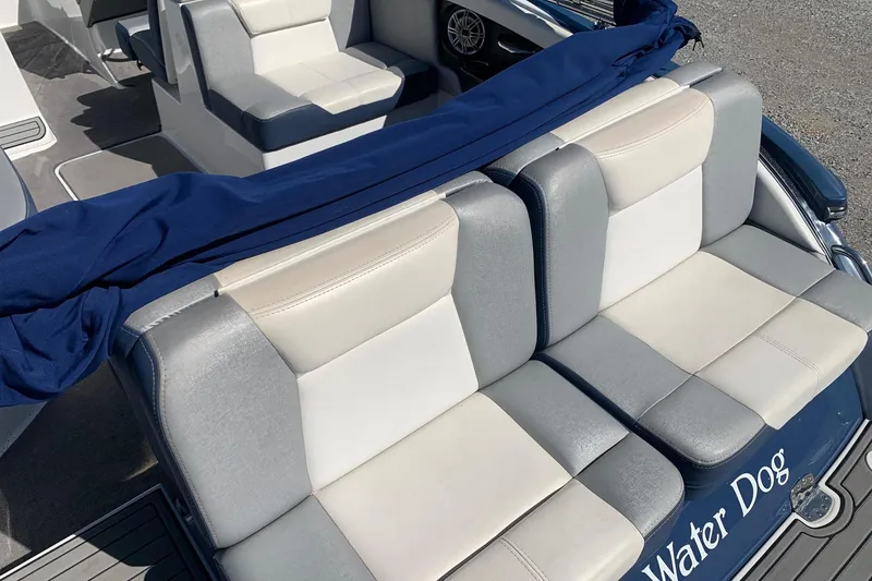 Slide: The Image of 2015 Bryant Calandra boat interior with gray and white seating, blue cover, and "Water Dog" text. - 6