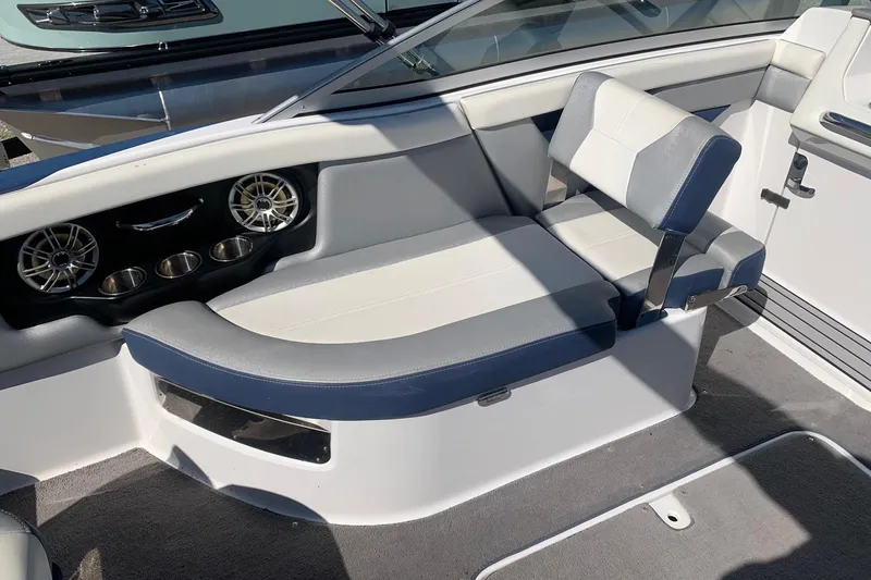 Slide: The Image of Interior of a 2015 Bryant Calandra boat with gray and white seating. - 7