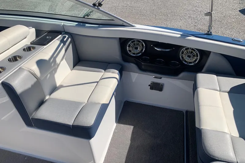 Slide: The Image of 2015 Bryant Calandra boat interior with cushioned seating and cup holders. - 8