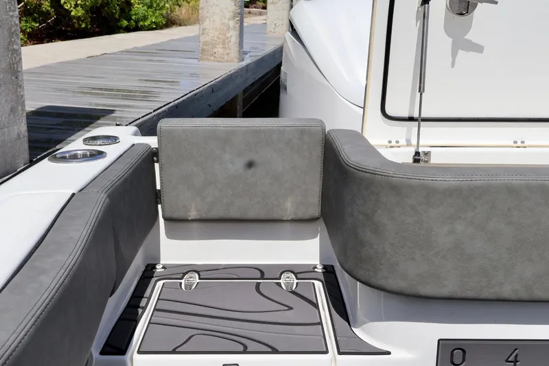 Slide: The Image of 2022 Sea Hunt Gamefish 30 Coffin Box boat interior with gray seating and deck. - 10