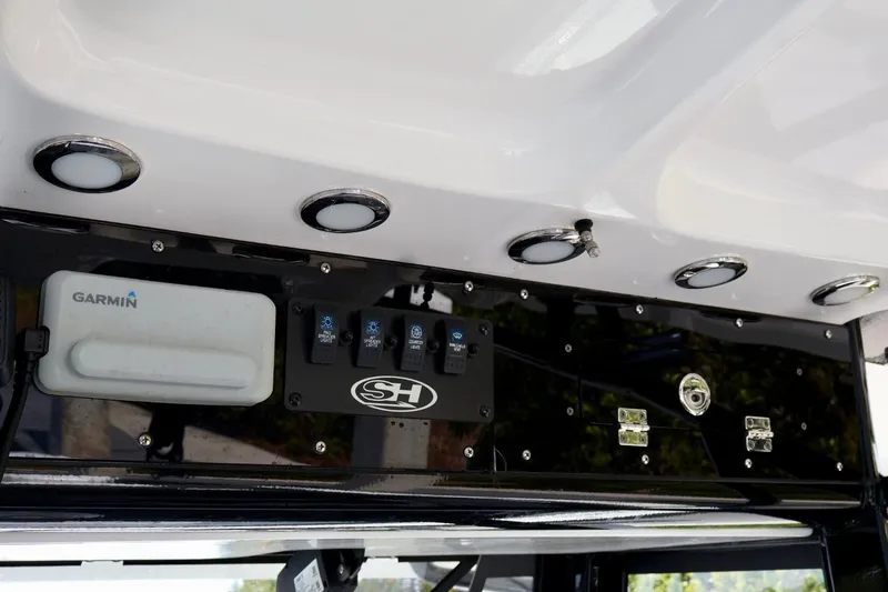 Slide: The Image of 2022 Sea Hunt Gamefish 30 Coffin Box dashboard with Garmin electronics and control switches. - 19