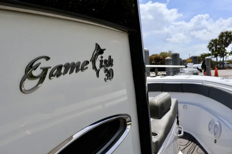 Slide: The Image of 2022 Sea Hunt Gamefish 30 Coffin Box boat, sleek design, sunny marina backdrop. - 21