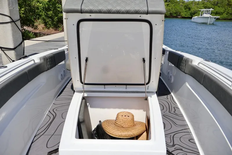 Slide: The Image of 2022 Sea Hunt Gamefish 30 Coffin Box open, revealing storage with a straw hat inside. - 25