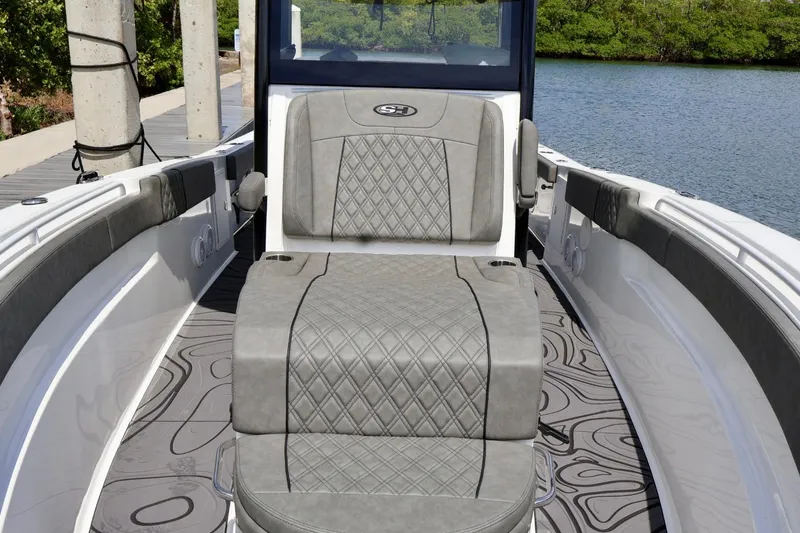 Slide: The Image of 2022 Sea Hunt Gamefish 30 Coffin Box boat interior with cushioned seating and stylish design. - 26