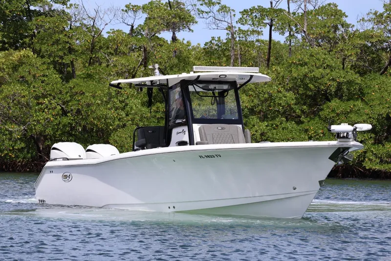 Slide: The Image of 2022 Sea Hunt Gamefish 30 Coffin Box boat cruising on a calm waterway. - 5