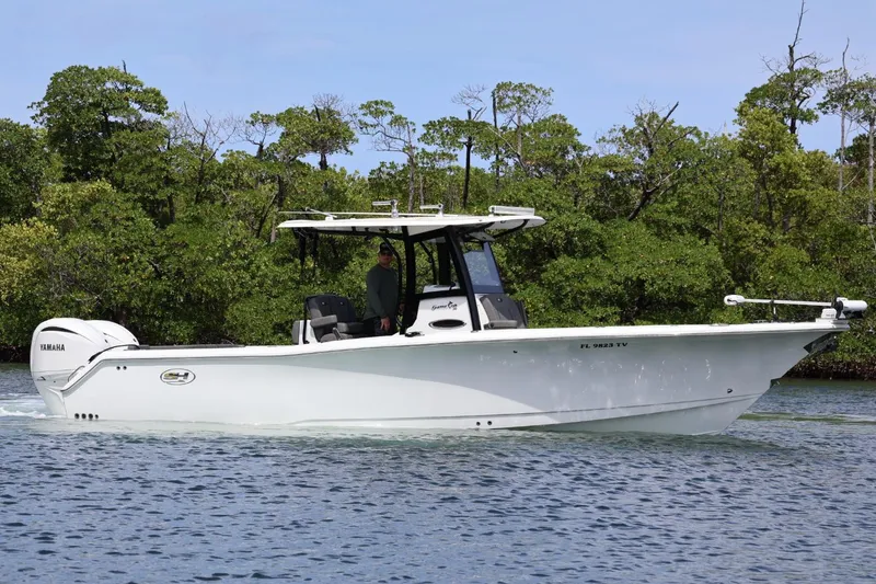 Slide: The Image of 2022 Sea Hunt Gamefish 30 Coffin Box boat cruising on a calm waterway. - 6