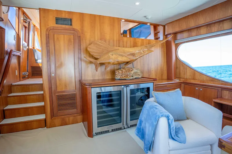 Slide: The Image of Luxurious 2001 Symbol 62 Pilothouse Yacht interior with wood paneling and ocean view. - 16