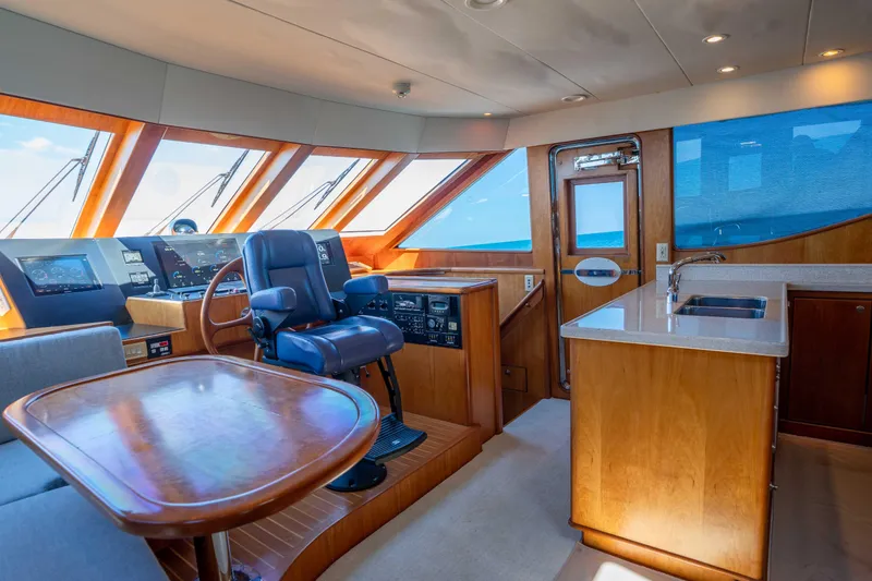 Slide: The Image of Luxurious interior of a 2001 Symbol 62 Pilothouse Yacht with helm and kitchenette. - 18