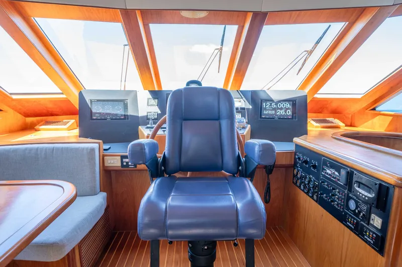 Slide: The Image of Pilothouse interior of 2001 Symbol 62 Pilothouse Yacht with navigation equipment and captain's chair. - 19