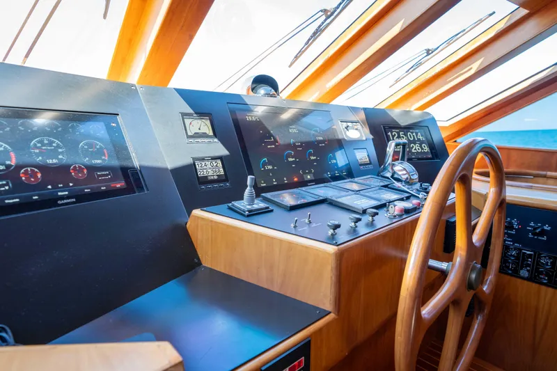 Slide: The Image of Pilothouse of 2001 Symbol 62 Yacht with modern navigation instruments and wooden steering wheel. - 21