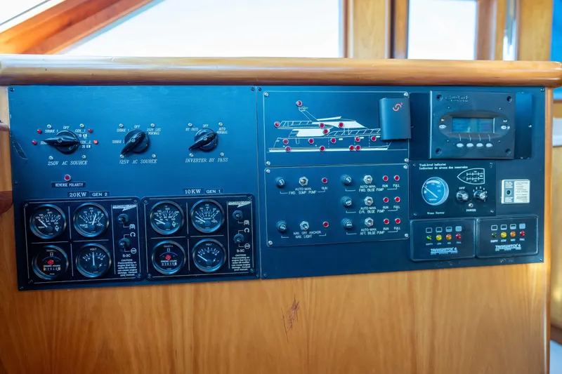 Slide: The Image of Control panel of a 2001 Symbol 62 Pilothouse Yacht with various gauges and switches. - 22