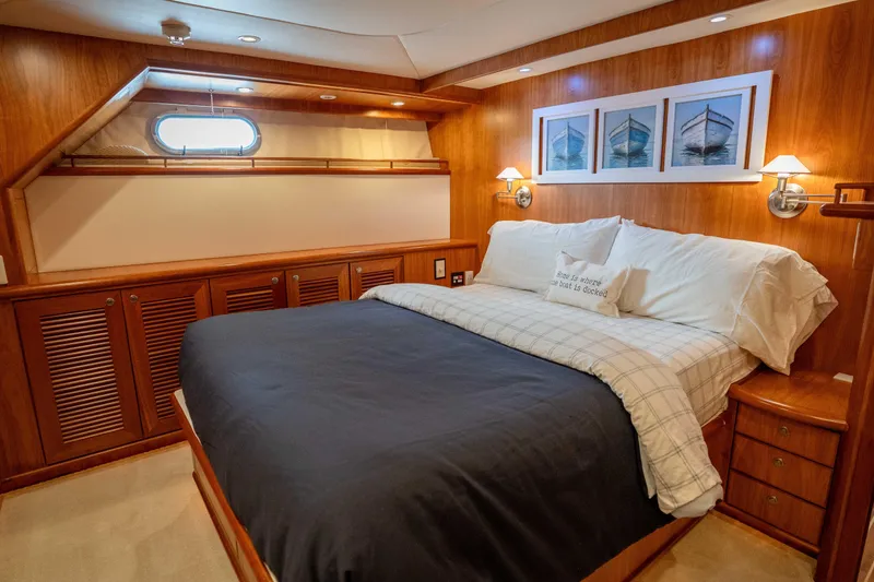 Slide: The Image of Luxurious bedroom interior of 2001 Symbol 62 Pilothouse Yacht with wood paneling and cozy bedding. - 29