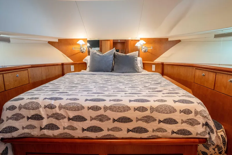 Slide: The Image of Luxurious bedroom interior of 2001 Symbol 62 Pilothouse Yacht with fish-patterned bedding. - 32