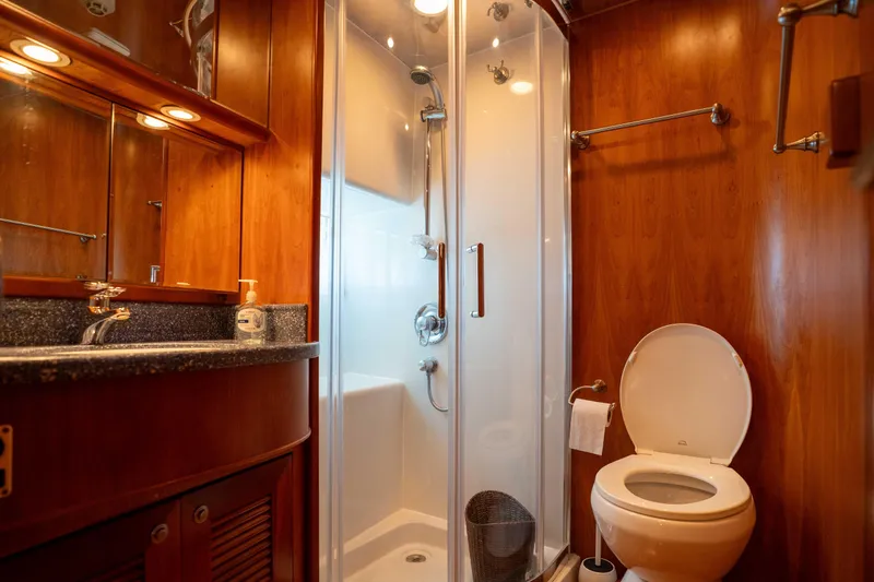 Slide: The Image of Luxurious bathroom in 2001 Symbol 62 Pilothouse Yacht with wood accents and modern fixtures. - 33