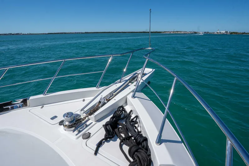 Slide: The Image of Bow of 2001 Symbol 62 Pilothouse Yacht on clear blue water. - 36