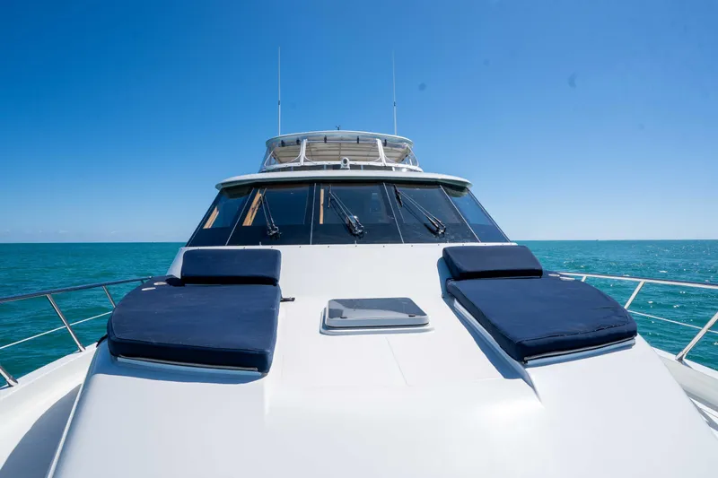 Slide: The Image of 2001 Symbol 62 Pilothouse Yacht with sun loungers on deck, cruising in clear blue waters. - 37