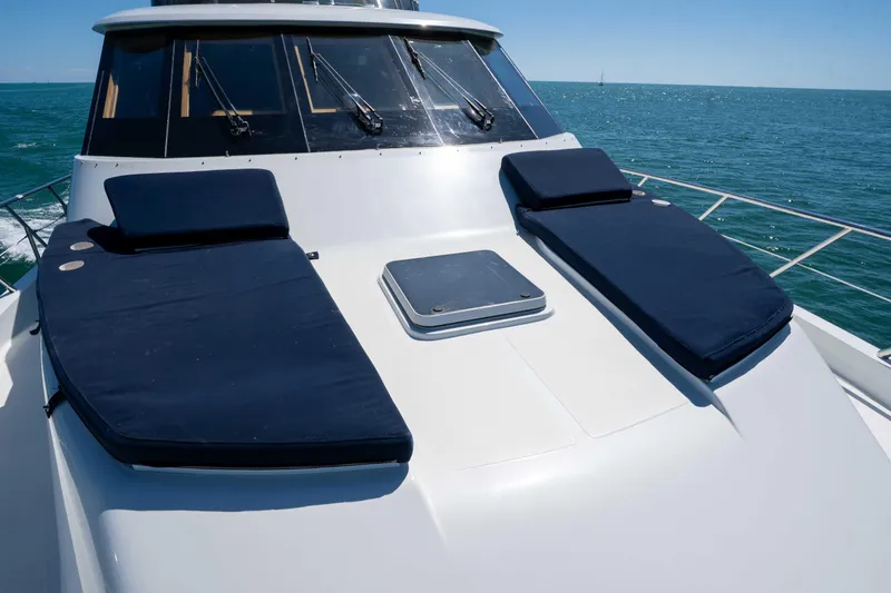 Slide: The Image of 2001 Symbol 62 Pilothouse Yacht with sun loungers on deck, cruising on open sea. - 38