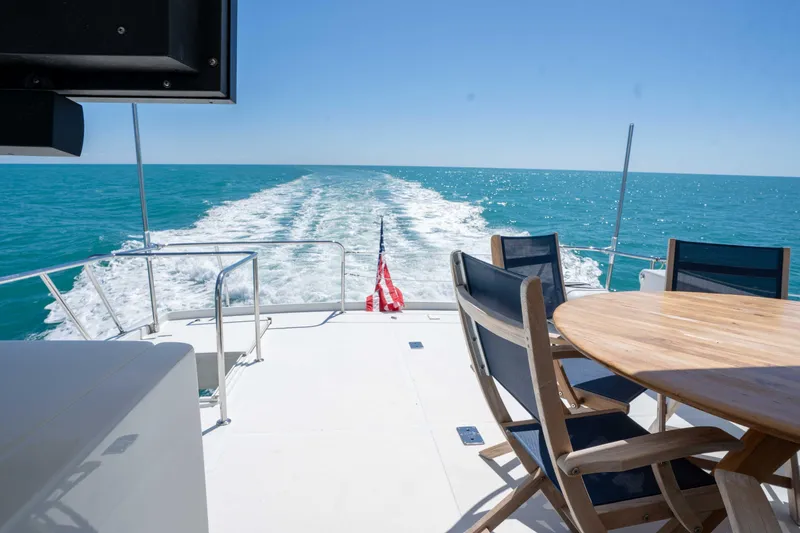 Slide: The Image of Aft deck of 2001 Symbol 62 Pilothouse Yacht with ocean view and seating area. - 39