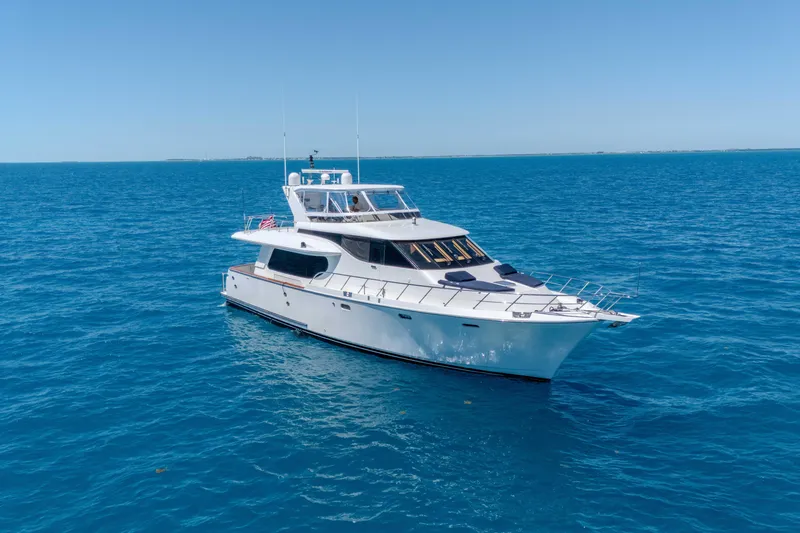 Slide: The Image of Luxurious 2001 Symbol 62 Pilothouse Yacht cruising on clear blue ocean waters. - 4