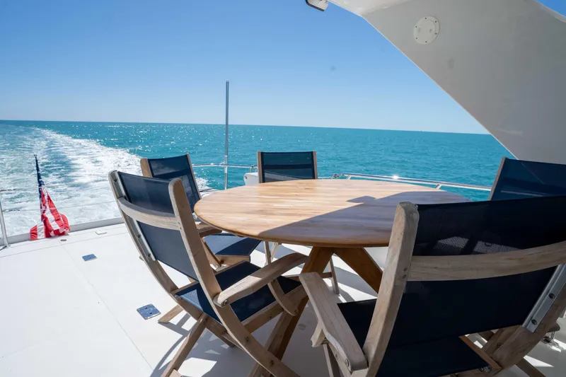 Slide: The Image of Outdoor seating on 2001 Symbol 62 Pilothouse Yacht, ocean view, sunny day. - 40