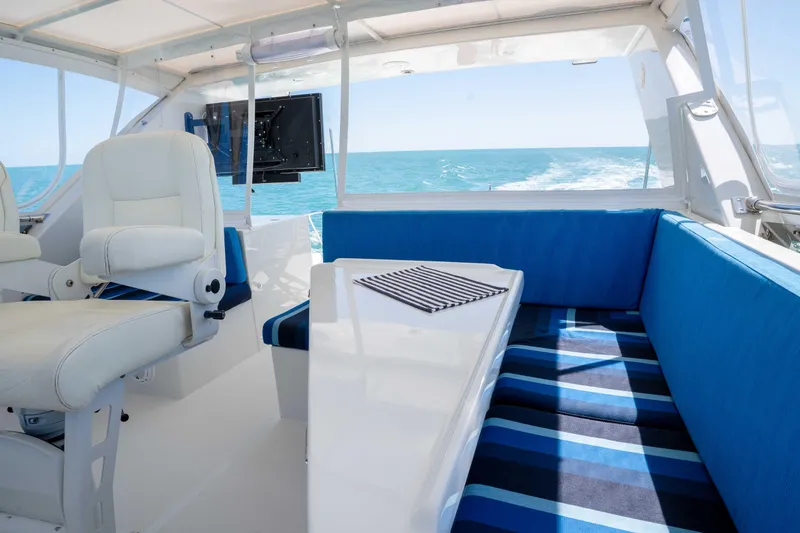 Slide: The Image of Luxurious interior of 2001 Symbol 62 Pilothouse Yacht with ocean view and seating area. - 43