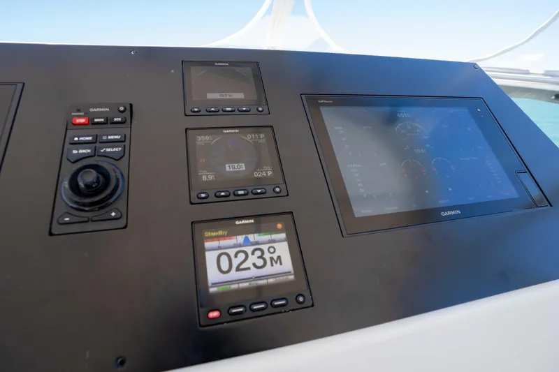 Slide: The Image of Control panel of a 2001 Symbol 62 Pilothouse Yacht with Garmin navigation displays. - 48