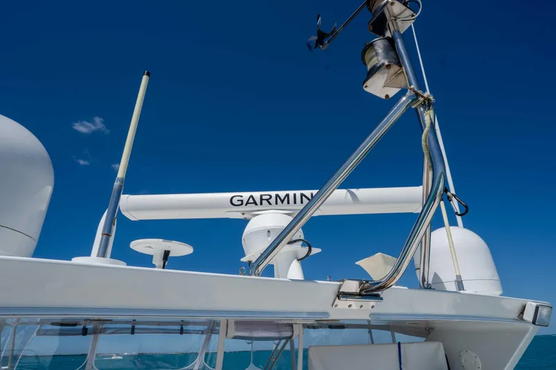 Slide: The Image of Radar equipment on a 2001 Symbol 62 Pilothouse Yacht under clear blue skies. - 50