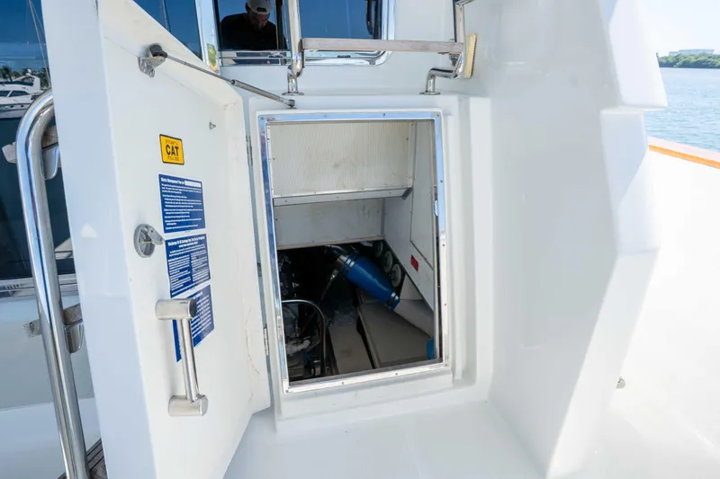 Slide: The Image of Engine room access on a 2001 Symbol 62 Pilothouse Yacht, featuring a CAT engine. - 51