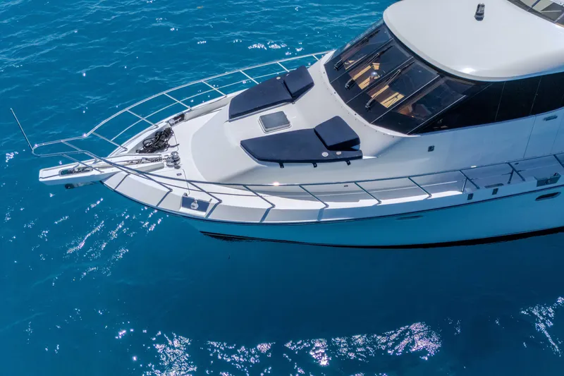 Slide: The Image of 2001 Symbol 62 Pilothouse Yacht on clear blue water, aerial view. - 6