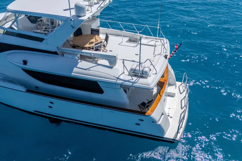 Slide: The Image of 2001 Symbol 62 Pilothouse Yacht cruising on clear blue water. - 7