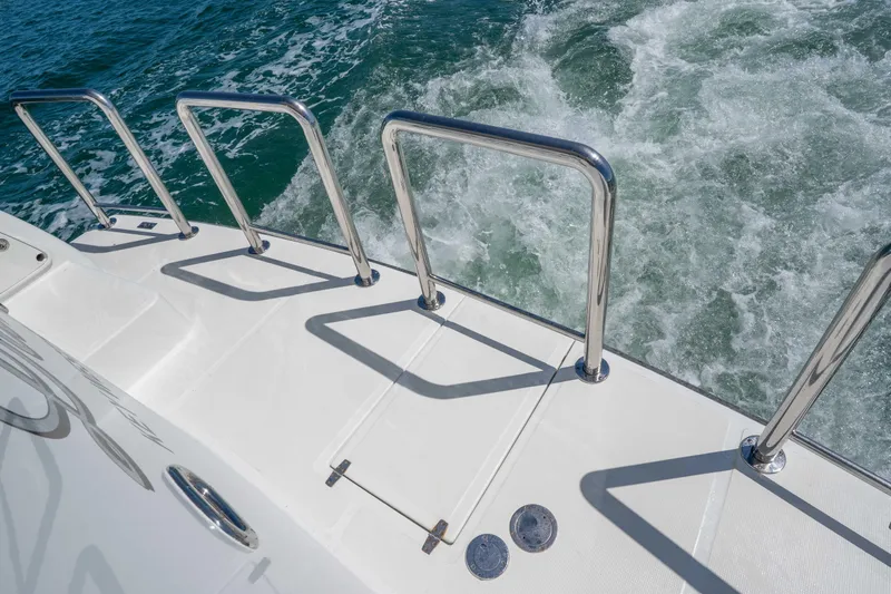 Slide: The Image of Deck view of 2001 Symbol 62 Pilothouse Yacht with stainless steel railings. - 9