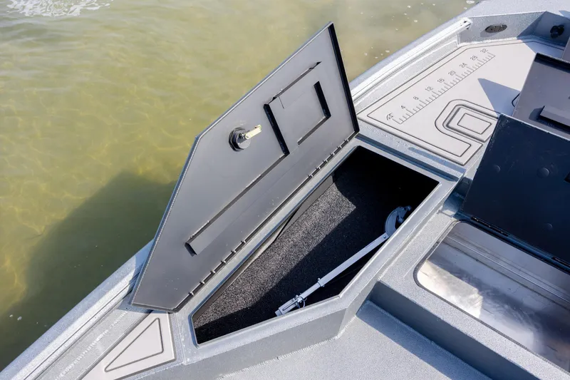 Slide: The Image of Open storage compartment on 2026 Excel 220 Bay Pro Elite boat. - 11