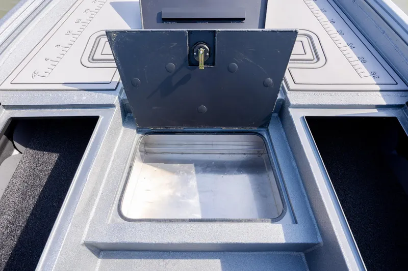 Slide: The Image of Open storage compartment on 2026 Excel 220 Bay Pro Elite boat deck. - 14