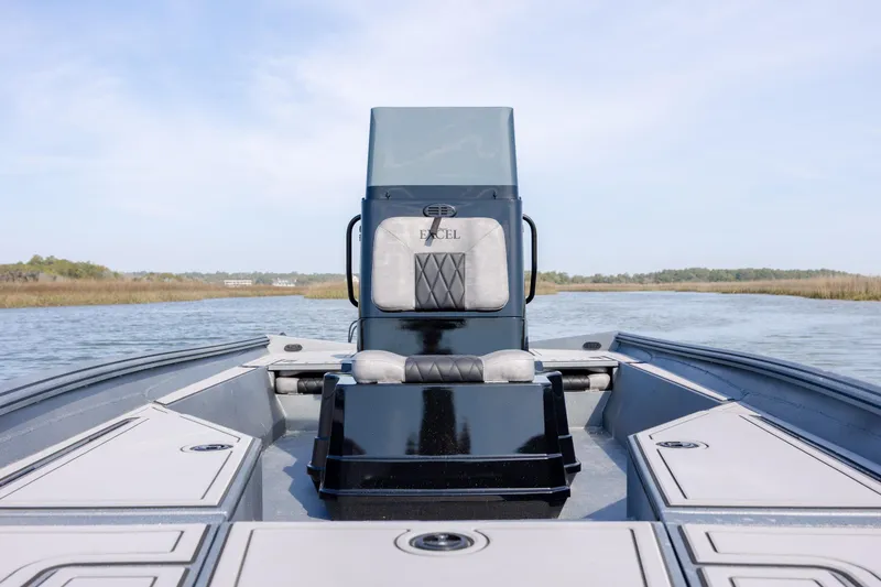 Slide: The Image of Excel 220 Bay Pro Elite 2026 boat on calm water, showcasing sleek design and spacious deck. - 18