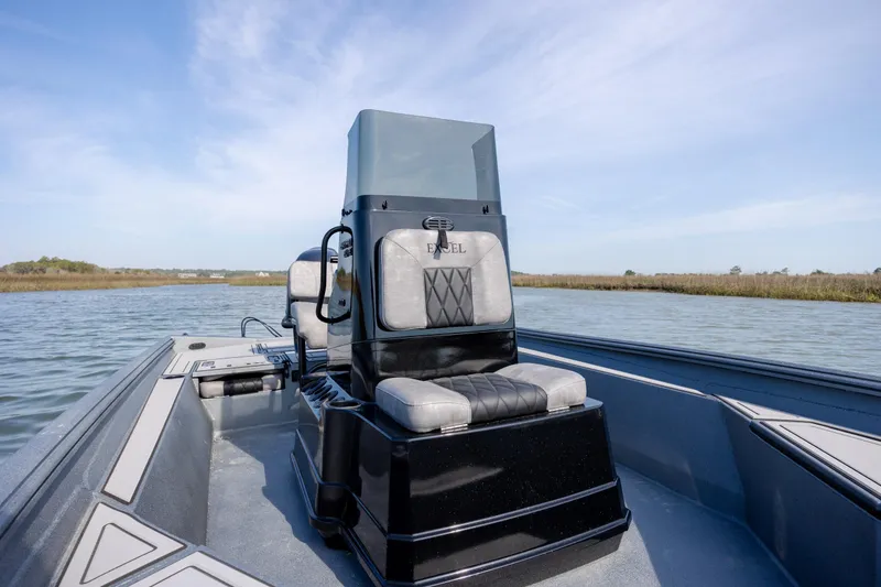 Slide: The Image of 2026 Excel 220 Bay Pro Elite boat on calm water, featuring sleek design and comfortable seating. - 19