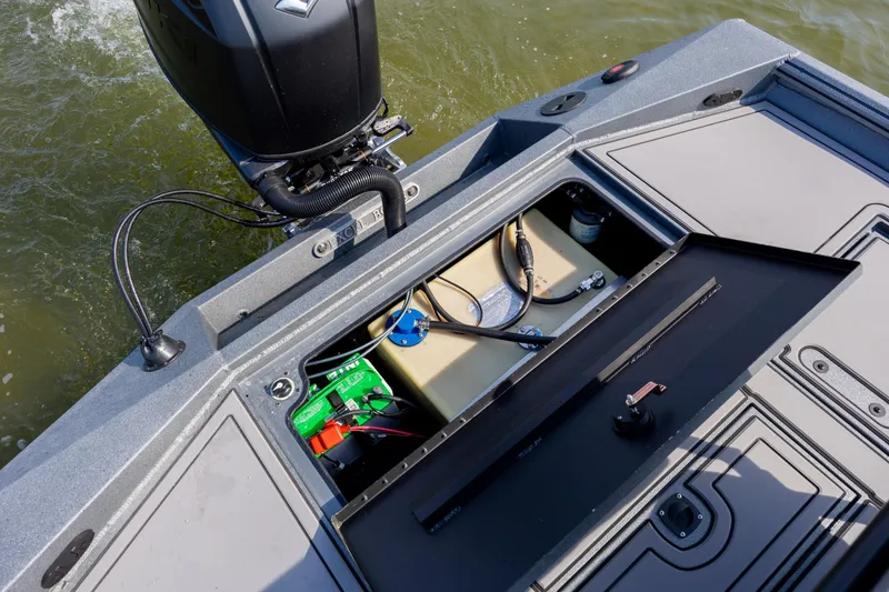 Slide: The Image of Open compartment of 2026 Excel 220 Bay Pro Elite boat showing engine and battery. - 32