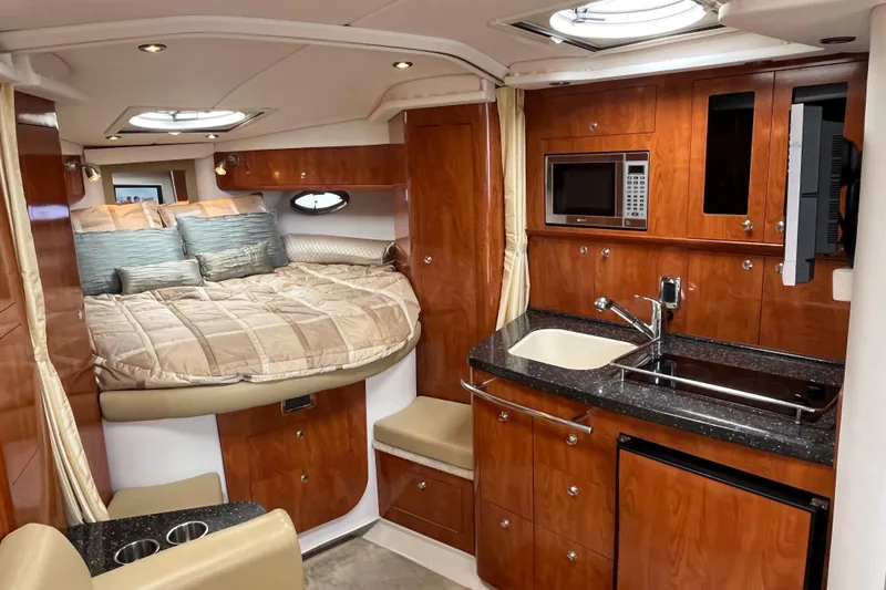 Slide: The Image of Luxurious 2008 Four Winns 338 Vista yacht interior with cozy bed and modern kitchenette. - 13