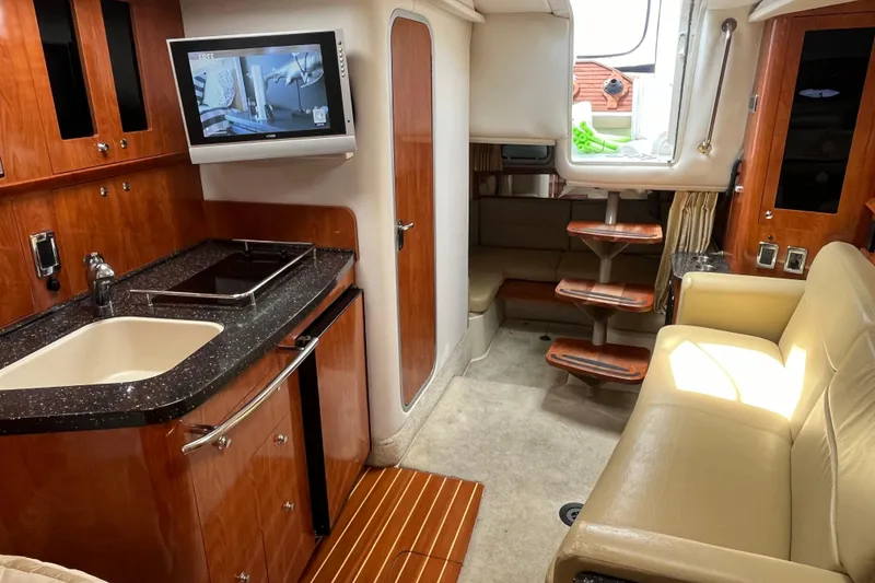 Slide: The Image of Luxurious interior of 2008 Four Winns 338 Vista yacht with kitchenette and seating area. - 14