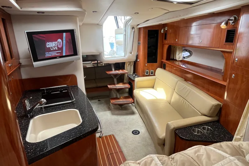 Slide: The Image of 2008 Four Winns 338 Vista yacht interior with kitchenette, sofa, and TV. Luxurious wood finish. - 15
