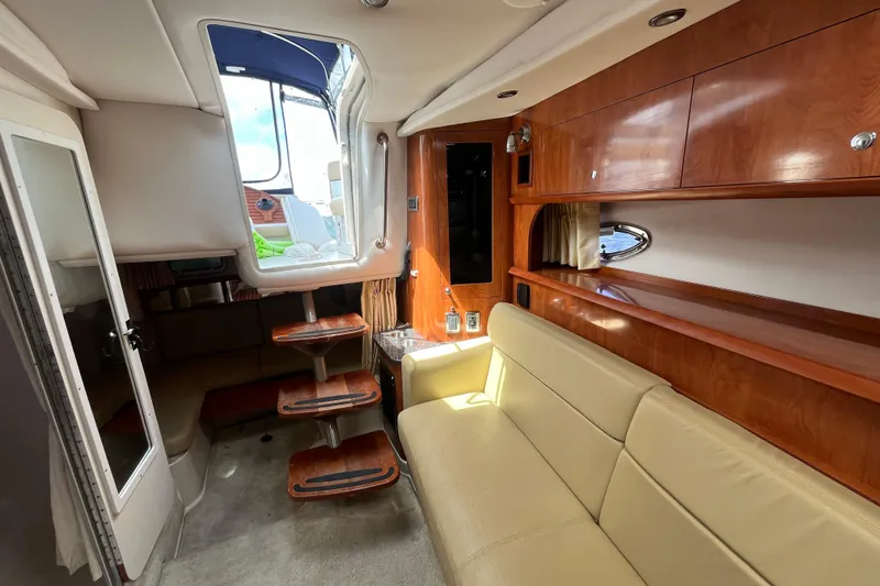 Slide: The Image of Interior of 2008 Four Winns 338 Vista yacht with wooden cabinetry and beige seating. - 18