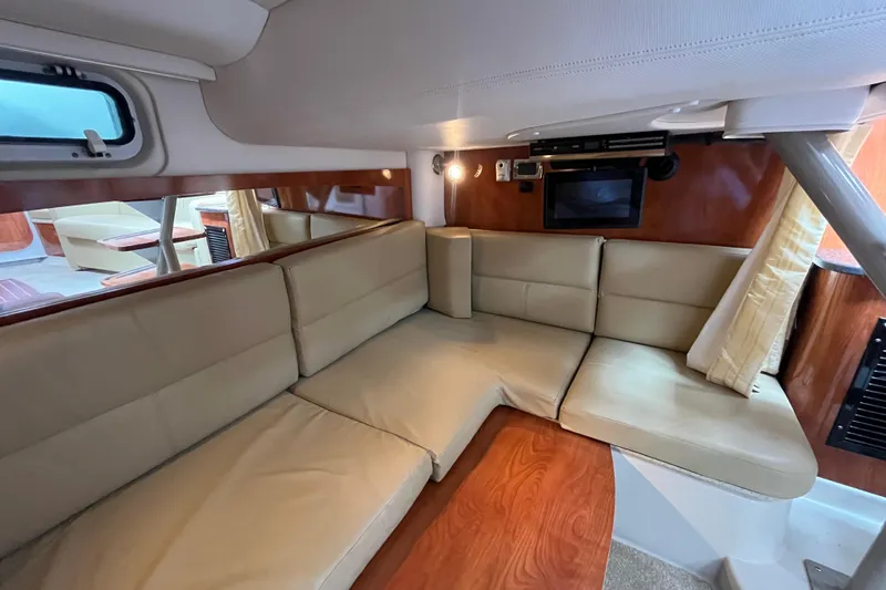 Slide: The Image of Interior of 2008 Four Winns 338 Vista yacht with beige seating and wood accents. - 19