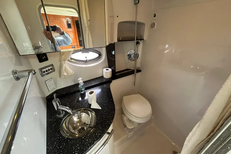 Slide: The Image of Compact bathroom in 2008 Four Winns 338 Vista yacht with sink, toilet, and mirror. - 23