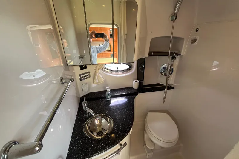 Slide: The Image of Compact bathroom in 2008 Four Winns 338 Vista yacht with sink, toilet, and mirror. - 24